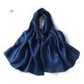 Macro detail of glossy dark blue silk scarf fabric showing soft texture and sheen - Dark Blue