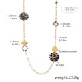 Macro detail of golden stainless steel chain with round acrylic leopard print discs - Gold Disc Leopard Print