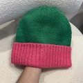Detail of green and pink contrasting knit beanie showing soft chunky yarn texture - One Size / Green and Pink