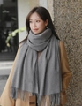 Pure gray thick winter scarf with elegant tassel trim worn by model outdoors - Cationic Viscose Style / 200x70cm / Medium Grey