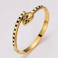 Golden snake bracelet with black and white enamel scales and green drop glue eyes - Gold