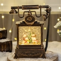 Vintage bronze Christmas phone snow globe featuring snowmen and decorated pine tree - Retro Telephone Four Snowmen