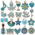 Blue enamel charms in heart, flower, and swan shapes with gold trim for DIY jewelry - Assorted Lake Blue Charms (SN998)