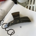 Detail of large translucent dark grey hair claw clip showing acrylic texture and spring - Dark Gray