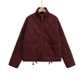 Detail of burgundy quilted jacket with a stand collar and zip closure on a white background - XS / Burgundy
