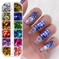 12-grid nail art foil set with metallic colors shown on long crystal nails with rhinestones - 12 Compartment Metal Foil Flakes Set (LX01)
