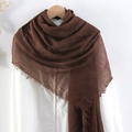 Brown crinkled cotton linen scarf with frayed edges hanging on a wooden hanger - Brown