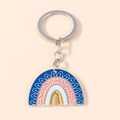 Rainbow acrylic keychain with blue and pink wavy patterns on a warm beige background - Abstract Geometric Rainbow