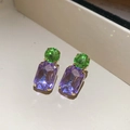 Macro detail of gold earrings featuring green round and purple square zircon stones - Silver Earring Post - Purple