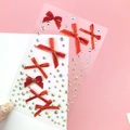 Sparkling red bow and iridescent crystal stickers for fairy-style eye makeup and face art - Red & Gold Bow Jewels (BJA-638)