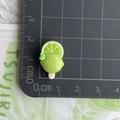 Macro view of a tiny 2cm green resin lime popsicle charm for hair clips and keychains - Green Lemon Popsicle