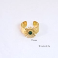 Detailed macro shot of vintage gold sunburst ring featuring a round green gemstone - Sun Green Gemstone Style