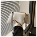 Detail of silver geometric chain bag featuring a metallic luster finish and chic flap closure - Silver