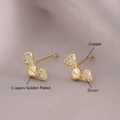 Elegant gold plated heart stud earrings with zircon stones on purple silk background - Triple Heart Style (EM06-10)
