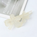 Elegant matte pale yellow butterfly hair clip with double-wing design on a white surface - Milk Yellow