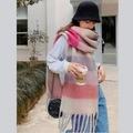 Detail of pink and grey gradient striped winter scarf with tassels shown on a model outdoors - Pink Grey Beige Gradient Stripes