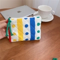 Detailed macro view of a colorful quilted cotton pouch with striped patterns and a zipper pull - Polka Dot Stripe Quilted