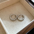 Macro shot of silver hoop earrings placed in a premium beige fabric jewelry box - Round Silver Ear Buckle (61#)