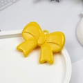 Vibrant yellow acrylic bow tie pendant with glossy finish and hanging loop for DIY jewelry - Yellow