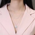Double-layered silver necklace with bar and textured coin pendants on model - Silver Double Layered (Set of 2)