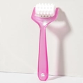 Detail of pink handheld scalp massager featuring a white textured rolling wheel - Rose Red