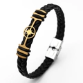 Close-up of black braided leather men's bracelet with gold maple leaf and silver buckle - Starburst