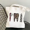 White canvas tote bag featuring creative dental theme print with leopard pattern tooth - C9 Plaid Leopard Tools