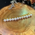 Detailed view of handmade golden wire hair clip with elegant white freshwater pearls - Pearl Hair Clip