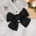 Elegant oversized black satin bow hair clip on a minimalist marble background - Hair Tie / Black