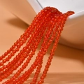 Macro shot of 2mm faceted orange crystal beads for DIY jewelry and necklaces - Red