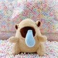 Plush capybara keychain with blue bubble nose detail on colorful macaron background - Runny Nose Light Brown + Bead Chain