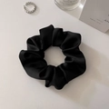Classic black satin scrunchie with silky luster on white textured background - Medium Black (approx. 10CM)