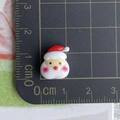 Close-up of small resin Santa Claus charm with ruler showing 2.5cm height dimension - 09-Chubby Santa Claus Head