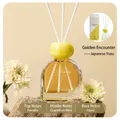 Detail of 80ml reed diffuser bottle with gold marble neck and white flower decoration - Japanese Yuzu 80ml