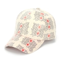 Detailed close-up of ivory baseball cap featuring black grid and red sunburst embroidery - One Size / Off White