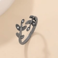 Adjustable black leaf ring with white zircon stones on a warm minimalist background - Black Leaf Zirconia Open Ring (Gun Black 3192)