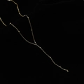 Detail of gold Y-shaped necklace with delicate beaded chain on black velvet - Round Ball Minimalist Necklace / Gold