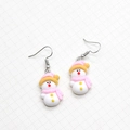 Detailed close-up of cute cartoon snowman resin drop earrings for Christmas holiday wear - Snowman