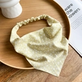 Detail of yellow daisy floral fabric headband on a wooden tray with a pastoral aesthetic - Yellow