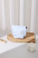 Close-up of light blue striped makeup bag with bow embroidery and flower zipper pull - Blue Bowknot (Small)