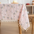 Pink floral cotton linen tablecloth with white tassel edge on wooden table surface - Elegant Pink Floral