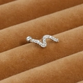 Close-up of S-shaped silver ear stud with micro-paved zircons on brown velvet display - S-Shape