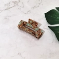 Detail of a rectangular acetate hair claw with green and brown marble texture design - Coffee Floral (Medium)