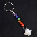 Rainbow crystal beads keychain with white Merkaba star stone pendant on black surface - Agate