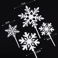White snowflake cake toppers set in three sizes with elegant intricate cutouts - 4pcs Silver Acrylic Snowflakes with Sticks
