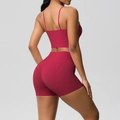 Detail of burgundy backless yoga set featuring thin straps and high-waisted gym shorts - Carmine