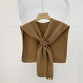 Camel knitted shawl scarf with front knot design on a wooden hanger against white wall - Coffee