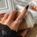 Chic rose gold frog ring with white crystal pavé shown in a stylish hand-held lifestyle shot - Rose Gold 0597