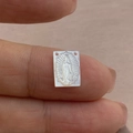 Macro shot of hand holding a carved white mother of pearl Guadalupe shell pendant - Small Size (3351) / 8x11mm