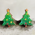 Festive wooden Christmas tree stud earrings with colorful ornaments on a stone surface - Christmas Tree
